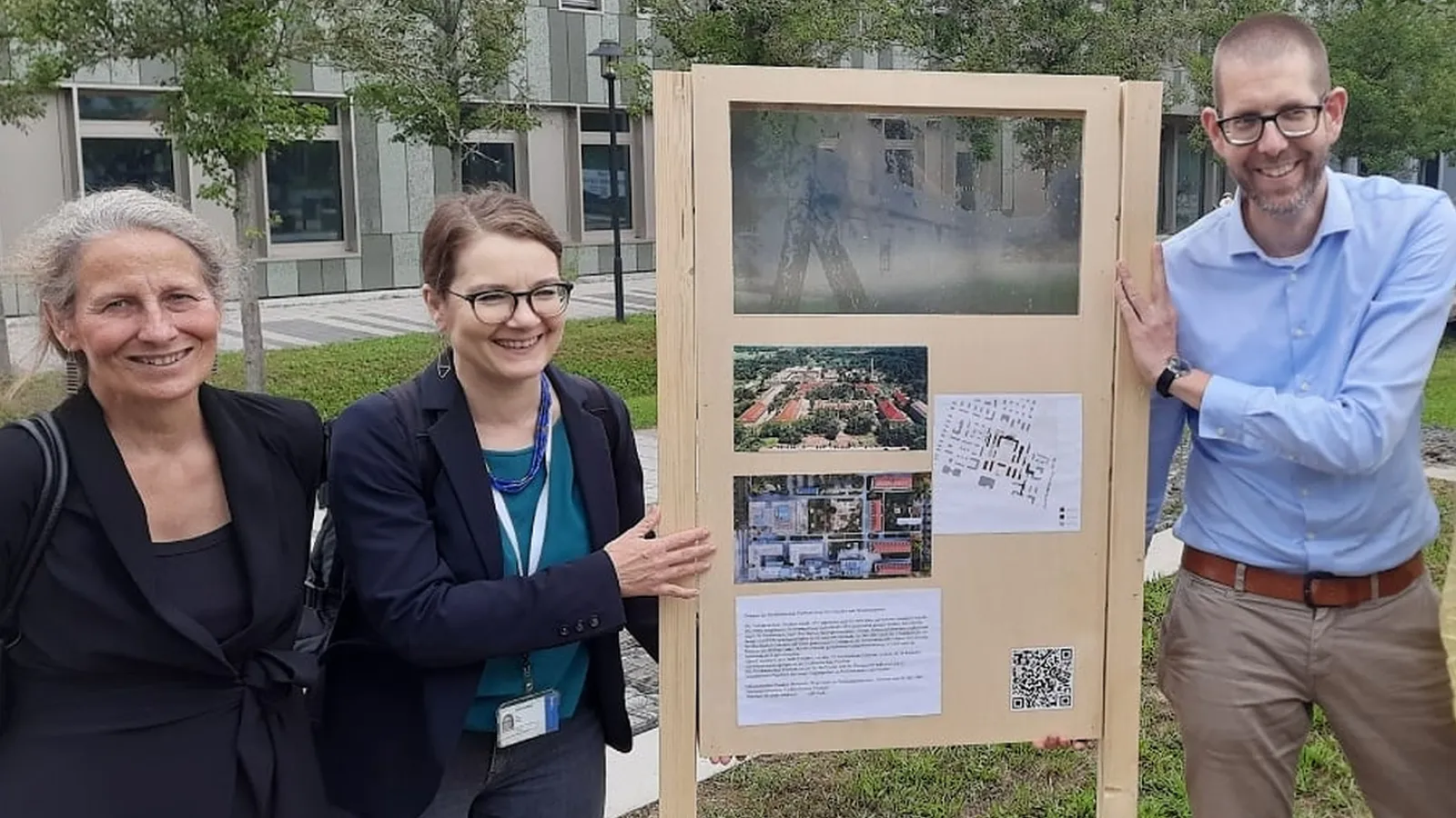 Prof. Dr. Eva Schmitt-Rodermund, Prof. Dr. Ulrike Wuttke und Prof. Dr. Rainer Schützeichel mit dem Prototyp des “Bornstedter Zeitfensters” auf dem FHP-Campus / Der Prototyp besteht aus einem Holzgetstell mit Campus-Bildern und Textpassagen